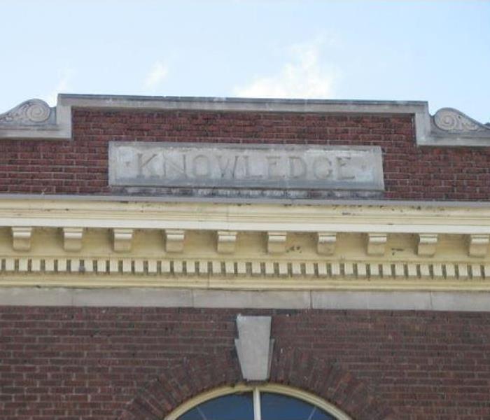 The word "Knowledge" on a brick wall