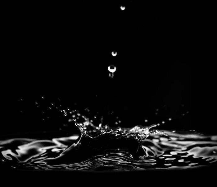Water dripping with black background